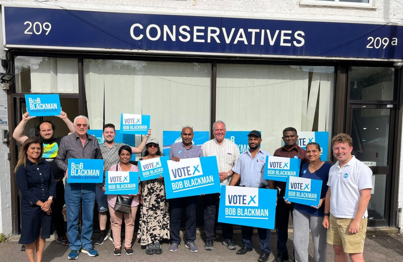 Bob Blackman MP with a team of activists out front the Harrow East Conservative Office holding up Vote Conservative signs