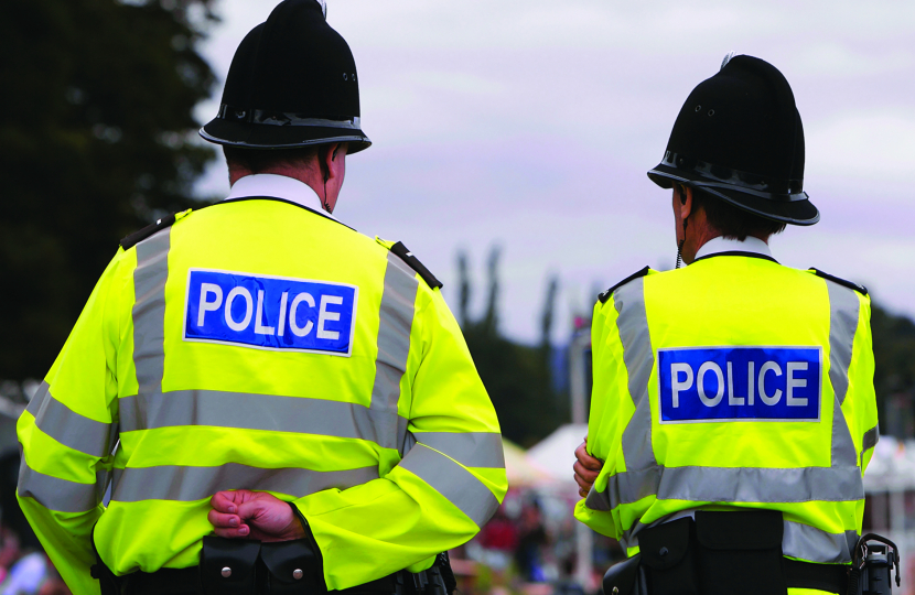 Photo of two police officers walking down the street