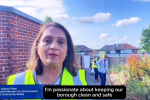 Cllr Anjana Patel in a high viz jacket in Rayners Lane. In the background is a wall and some houses. 