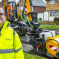 Cllr Osborn stood in front of the Council's new JCB pothole pro machine in a road which has been resurfaced.