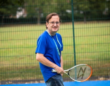 Cllr Osborn playing tennis at Byron Park's refurbished tennis courts