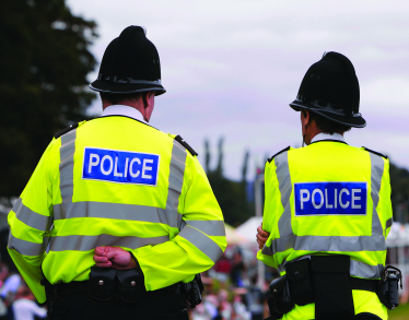 Police officers in high viz walking the beat